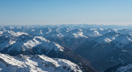 Vast Snowy Mountain Range Under a Clear Blue Sky