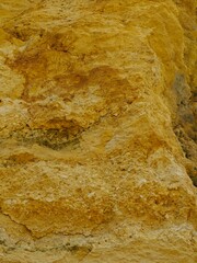 Eroded Sandstone Cliff Face Textural Layers in Golden Light.