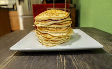 A big stack of fluffy pancakes. American family breakfast.