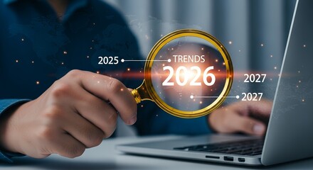 Person's hand holding a magnifying glass over the year 2026 analyzing future trends and projections with dates 2025 and 2027 visible Analysis Data Technology