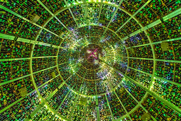 Interior view from below of a giant Christmas tree structure with green lights forming concentric patterns