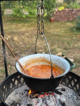 Hungarian goulash cooking in kettle on open fire