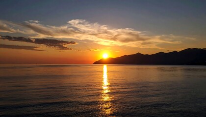 Obraz premium Seascape at Sunset: A Tranquil Scene of Coastal Mountains and Reflective Waters