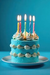 Layered blue birthday cake with lit candles against a blue background, dessert, tasty