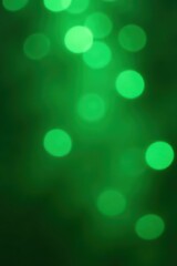 Emerald green bokeh, sparkling highlights, lively atmosphere, iridescent, light, happy