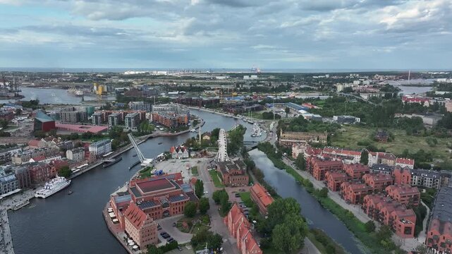 Aerial Gdansk Poland old town along river pull 1 4K. Baltic coast of northern Poland. World War II started here with German invasion. Economic international port. Historical buildings, tourism.