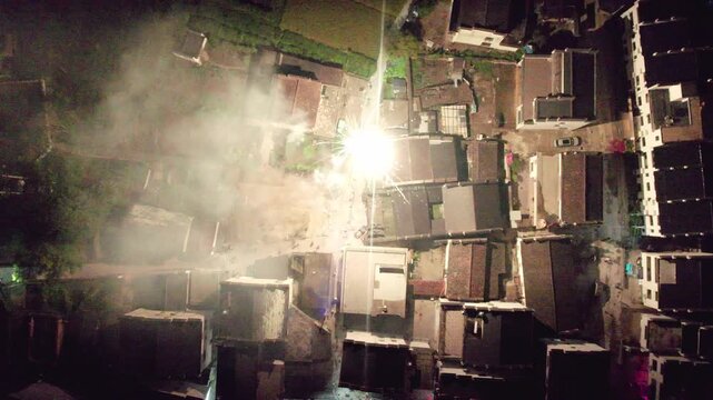 Drone view of fireworks set off during New Year celebrations in Wuyuan, Jiangxi, China. Top view of dragon dance in rural China in spring festival at night, 4k real time footage.