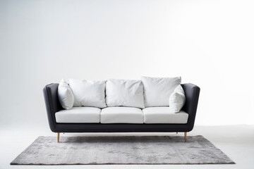 A picture of a grey sofa with a white background