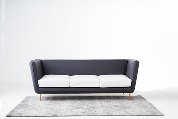 A picture of a grey sofa with a white background