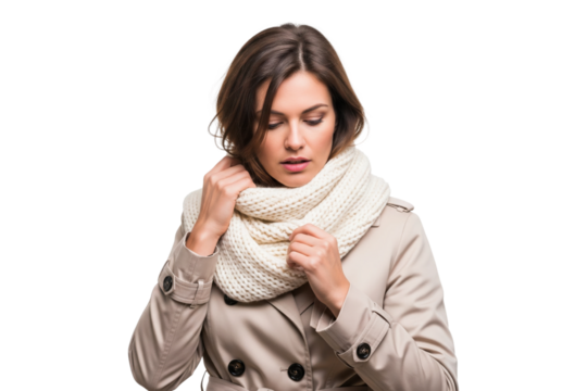 Stylish woman in a beige trench coat adjusting her cozy white knit scarf for autumn.