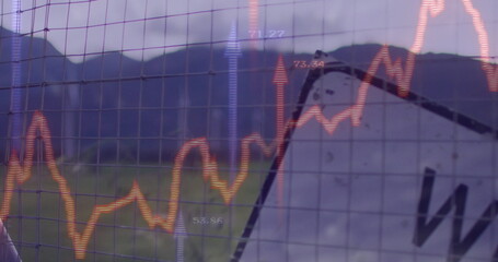 Displaying metal wire-mesh fence over grassy mountain field, with orange line chart, arrows, labels