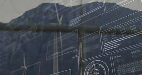Displaying wind turbine tower showing digital data panels on rugged mountain ridge, graphs