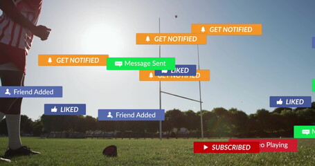 Standing teen athlete wearing red jersey on field with rugby ball and notifications, copy space