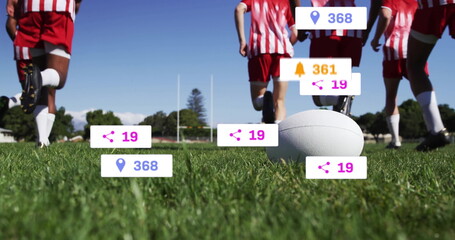 Running team in red and white jerseys sprinting across rugby field, with white ball in foreground