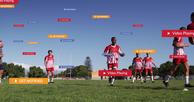 Running athlete in red jersey raising arms on outdoor soccer field, with floating alert banners - Powered by Adobe