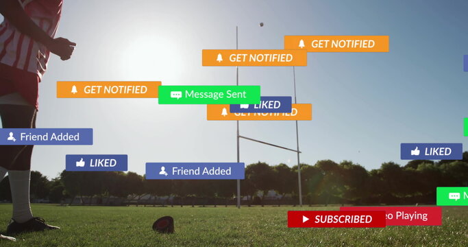 Standing teen athlete wearing red jersey on field with rugby ball and notifications, copy space