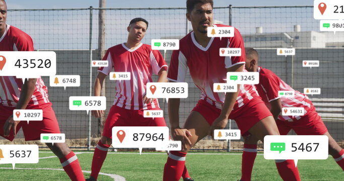 Executing warm-up lunges by seven soccer players in red jerseys on turf field, with overlay icons