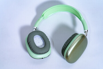 Modern wireless headphones lying on white background