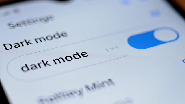Dark mode settings interface displayed on a smartphone with a blue toggle enabled