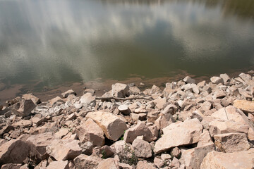 On the shore of a lake there is a mountain of stones that mark the shore and the beginning.