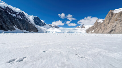 Fototapeta premium Wide shot of glacier and snowy peaks under clear blue sky, showcasing stunning natural beauty