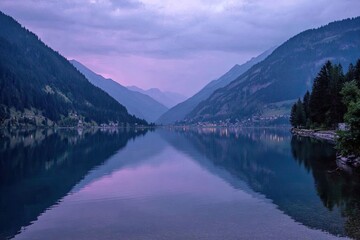 Serene alpine lake at twilight, mirrored reflections