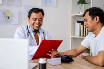 Fototapeta premium Adult Asian Doctor Man Reporting Medical Results to Young Man Patient in Hospital Clinic