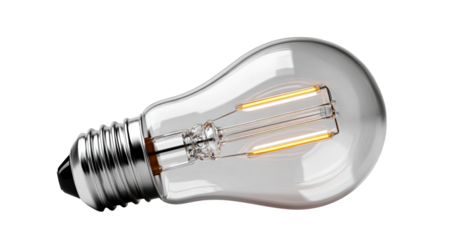 Modern clear glass light bulb with filament glowing warmly, cut out transparent