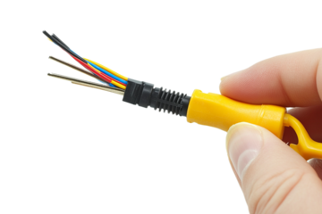 Hand holds colorful wires with a yellow handle tool