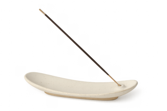 Incense stick burning on a ceramic incense holder with transparent background