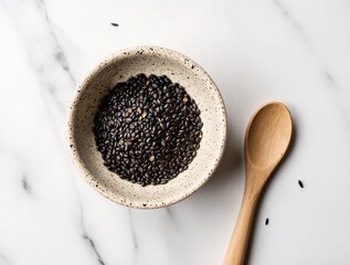 black sesame seeds in rustic bowl with wooden spoon on white marble surface | kitchen, food, cooking, natural, rustic theme