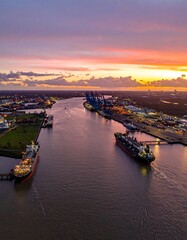 Naklejka premium Aerial view of cargo port at sunset