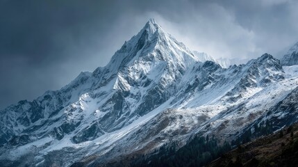 Snowy mountain peak under dramatic sky