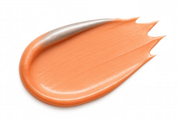 Smear of peachy orange cream foundation makeup with silver highlight, isolated on transparent background