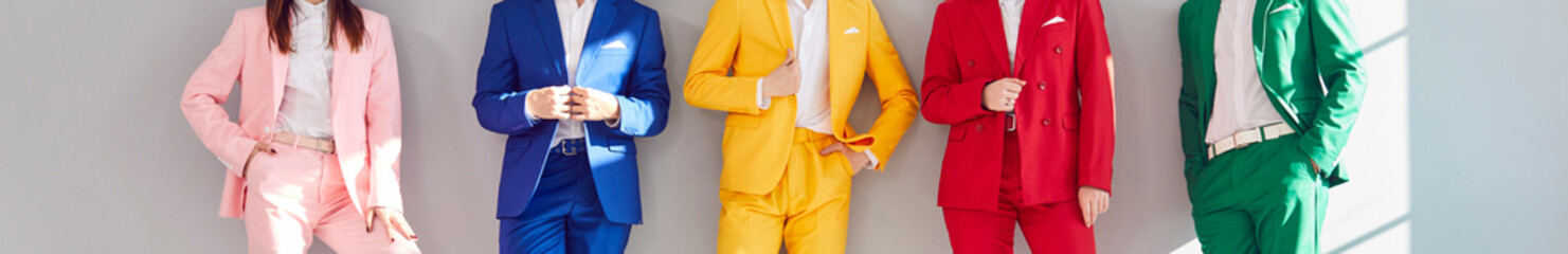 Fashion people group wearing bright vivid color suit standing posing in set of cool elegant clothes of summer design together, jacket and trousers, colleagues office formal modern outerwear