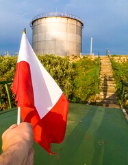 Flag near large tank
