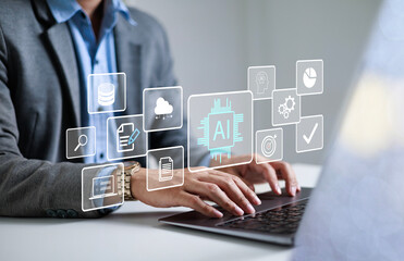 Businessman using laptop to control AI at desk in office. Artificial intelligence is analyzing data...