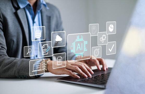 Businessman using laptop to control AI at desk in office. Artificial intelligence is analyzing data and generating reports. Artificial intelligence and intelligent automation (IA) technology.