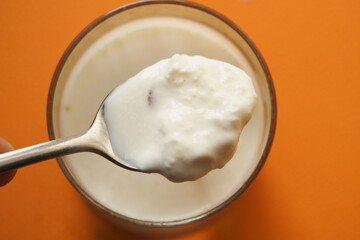 spoon pick fat cream from a glass of milk 
