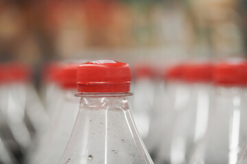 Bottles lined up in a grocery store aisle at daytime
