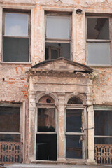 Abandoned building with weathered facade in urban setting