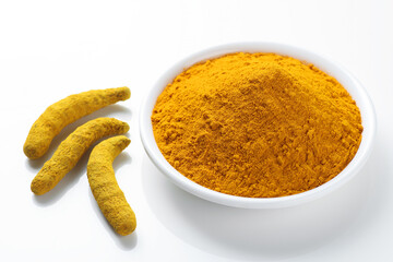 Indian spice called turmeric roots and powder isolated on white background 