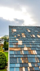 Damaged roof shingles, needing repair, showing wood underneath