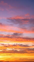 Obraz premium A stunning sky painted in vibrant shades of bright orange and deep blue, creating a breathtaking sunset that casts a warm glow over the horizon.