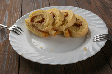 Delicious Homemade Swiss Roll Slices on Rustic Wooden Table