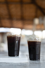 Ice black coffee or americano in plastic cups is medium roast and dark roast ice coffee at coffee shop.