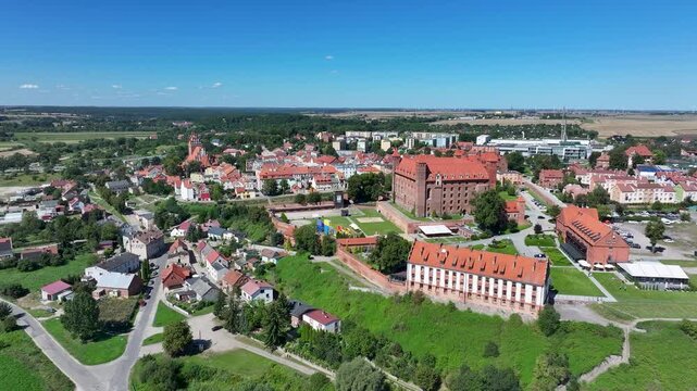 Aerial Gniew Poland historic brick castle and village 2. Northern Poland. Castle construction 13th century by Teutonic Knights. Vistula River. Agriculture land, river, forest and farm rural area.