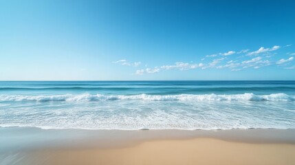 Obraz premium 114.Tranquil beach and ocean scene, with gentle waves and vast sandy shores under a bright blue sky, free from clouds, creating a serene and peaceful coastal environment.