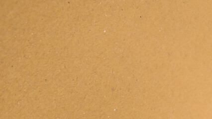 Background of brown kraft paper or cardboard texture. Abstract pattern of beige rough carton, old paper sheet.