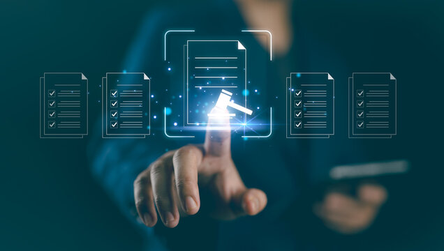 Compliance in business to laws and regulations, ethical operations. Businessman hand holding compliance icons on a virtual screen symbolizes the commitment to enforce standards and internal policies.